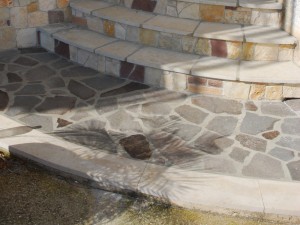 Pavimentazione opus incertum in porfido e fascia in pietra di modica antichizzata